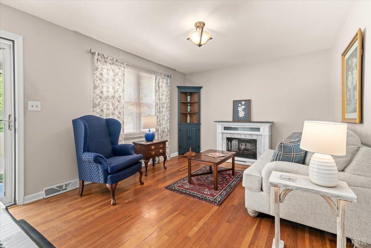 1752 Purdum Mill Road Appomattox, VA 24522 - Photo 7 of 38 a living room with furniture a fireplace and a table
