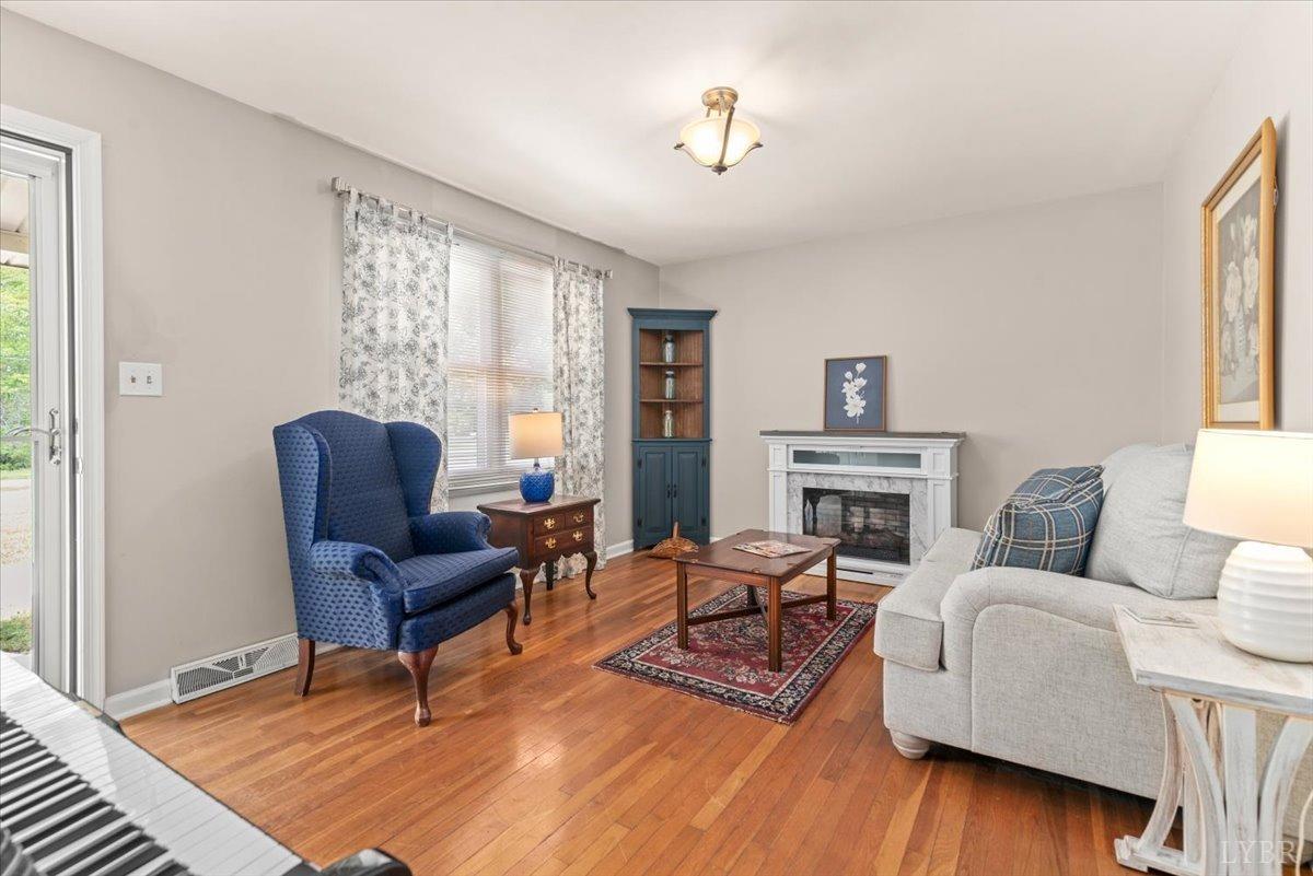 1752 Purdum Mill Road Appomattox, VA 24522 - Photo 8 of 38 a living room with furniture a fireplace and a table