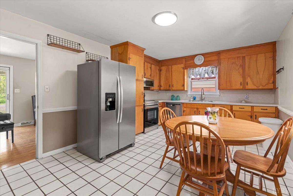 1752 Purdum Mill Road Appomattox, VA 24522 - Photo 10 of 38 a kitchen with stainless steel appliances granite countertop a refrigerator and a stove top oven