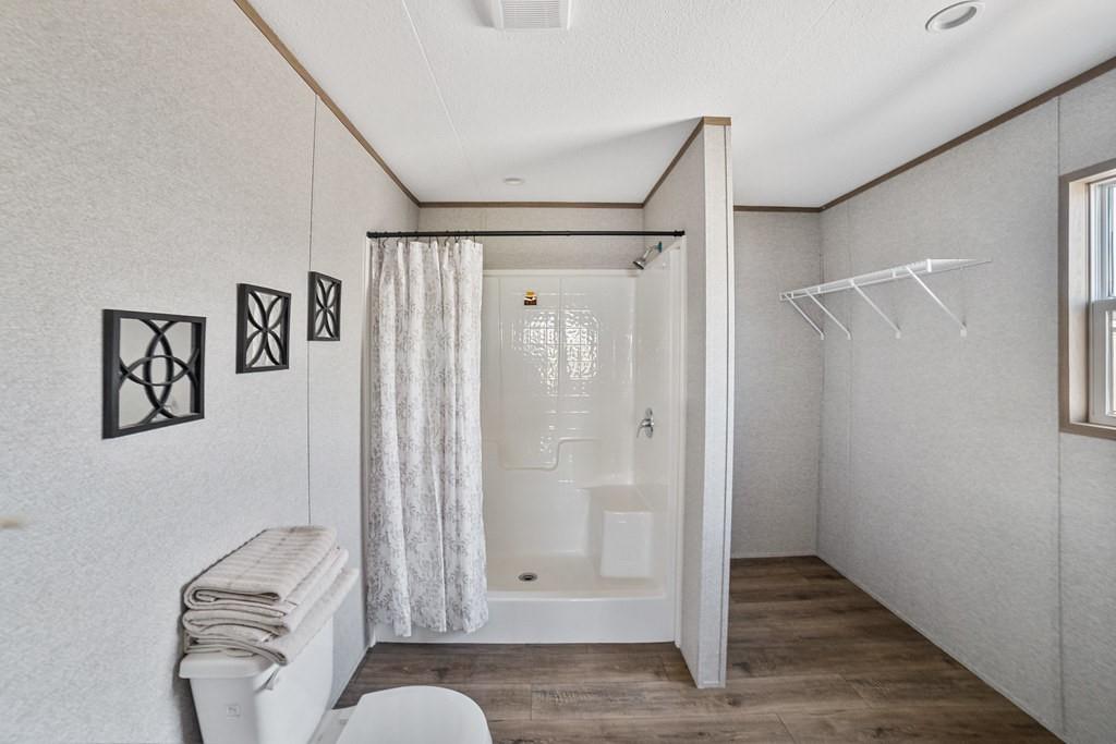 300 Huddleston Road Sunset, TX 76270 - Photo 24 of 38 a bathroom with a shower and a mirror