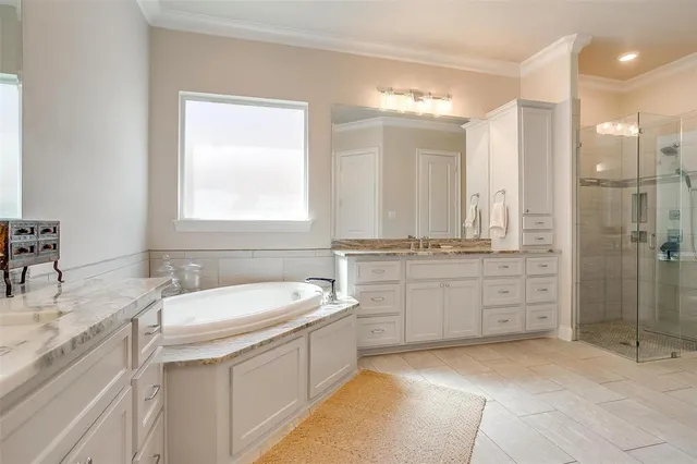 a bathroom with a sink double vanity and a shower
