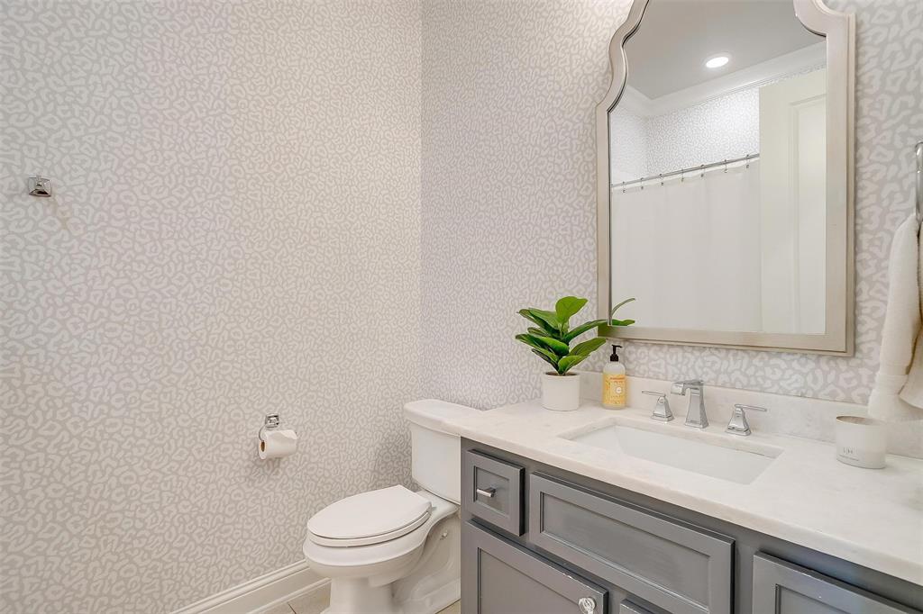 604 Rockfall Way Aledo, TX 76008 - Photo 17 of 33 a bathroom with a granite countertop sink a toilet and a mirror