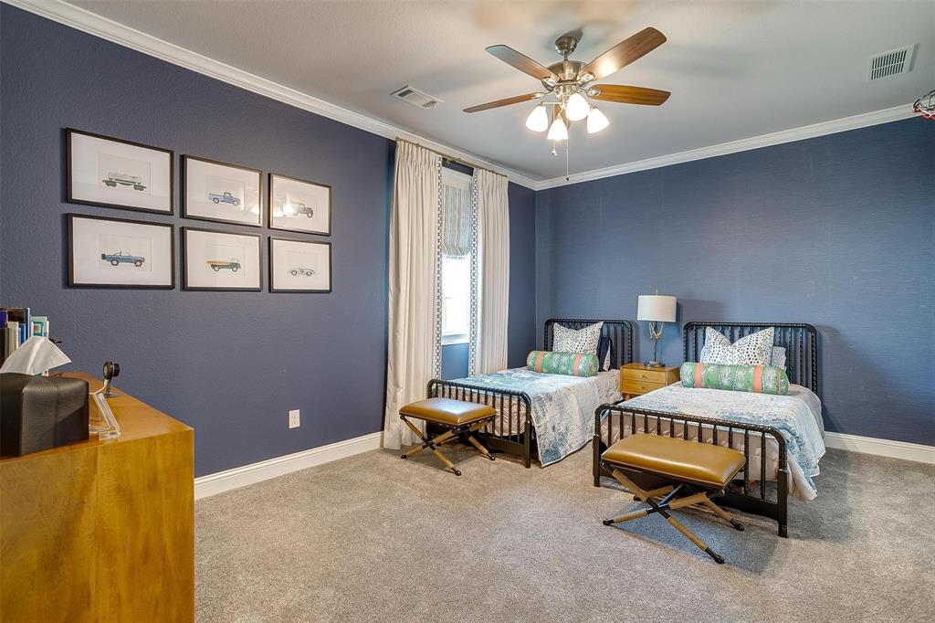 604 Rockfall Way Aledo, TX 76008 - Photo 25 of 33 a bedroom with a bed and a chandelier