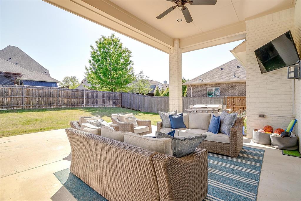 604 Rockfall Way Aledo, TX 76008 - Photo 28 of 33 a living room with furniture and a flat screen tv