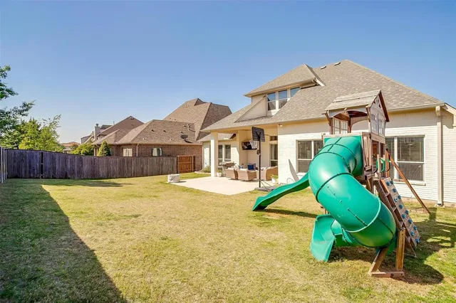 a view of a house with a backyard and a small cabin