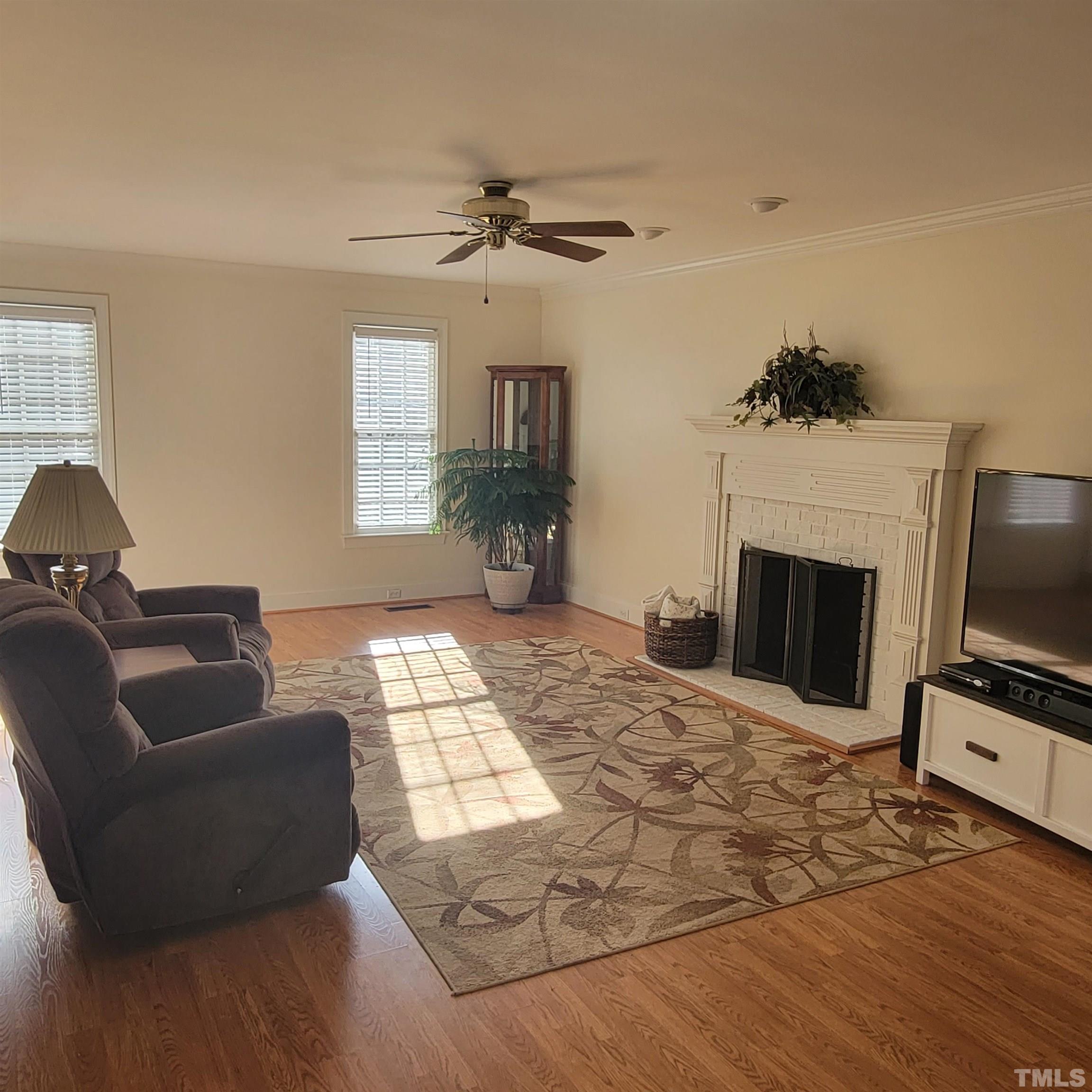 11817 Pembridge Lane Raleigh, NC 27613 - Photo 11 of 40 a living room with furniture and a fireplace