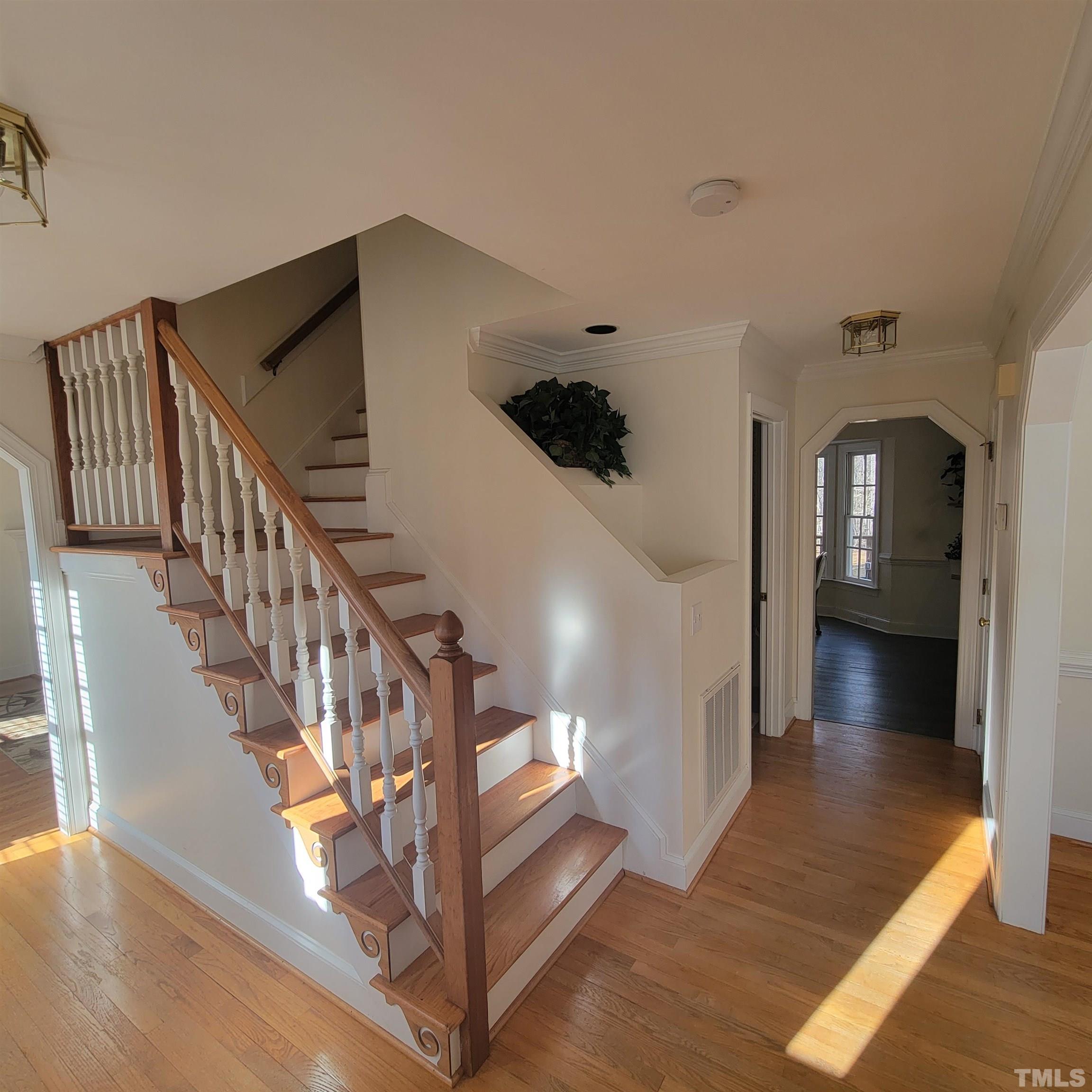 11817 Pembridge Lane Raleigh, NC 27613 - Photo 3 of 40 a view of entryway and hall with wooden floor