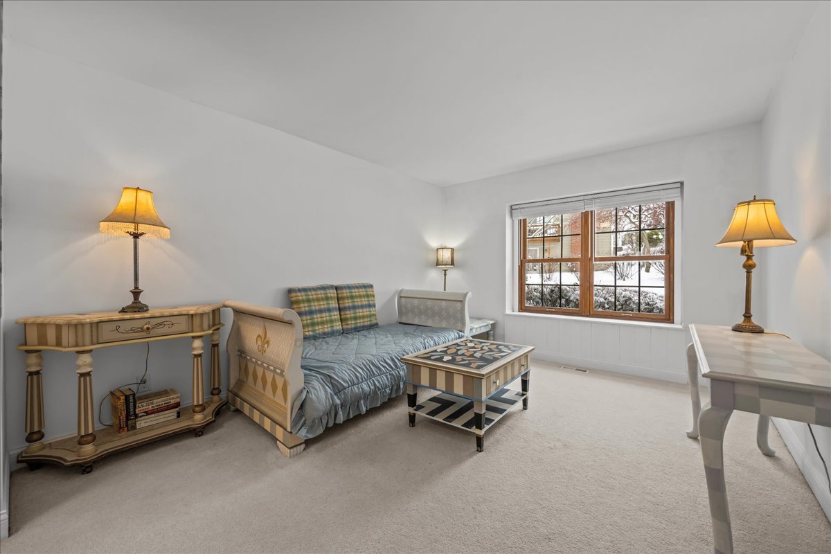 231 Sedgewick Circle St. Charles, IL 60174 - Photo 12 of 24 a spacious bedroom with a bed a chandelier and a window