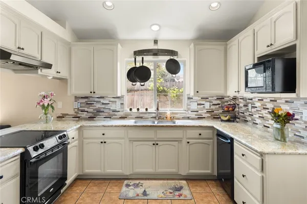 a kitchen with a sink stove and microwave