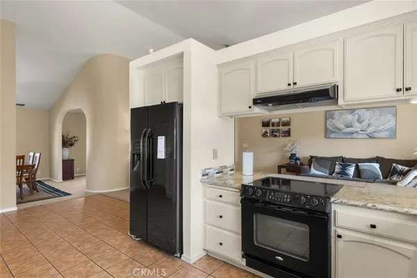 a kitchen with stainless steel appliances granite countertop a stove and a refrigerator