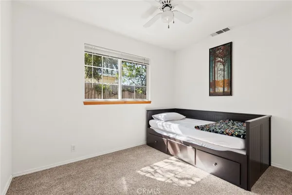 a bedroom with a bed and a window