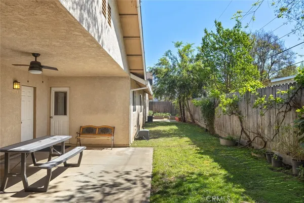 a view of a backyard with plants and a patio