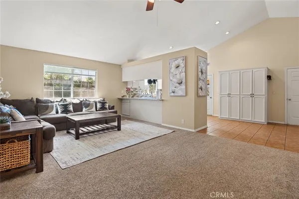 a living room with furniture and a open kitchen area