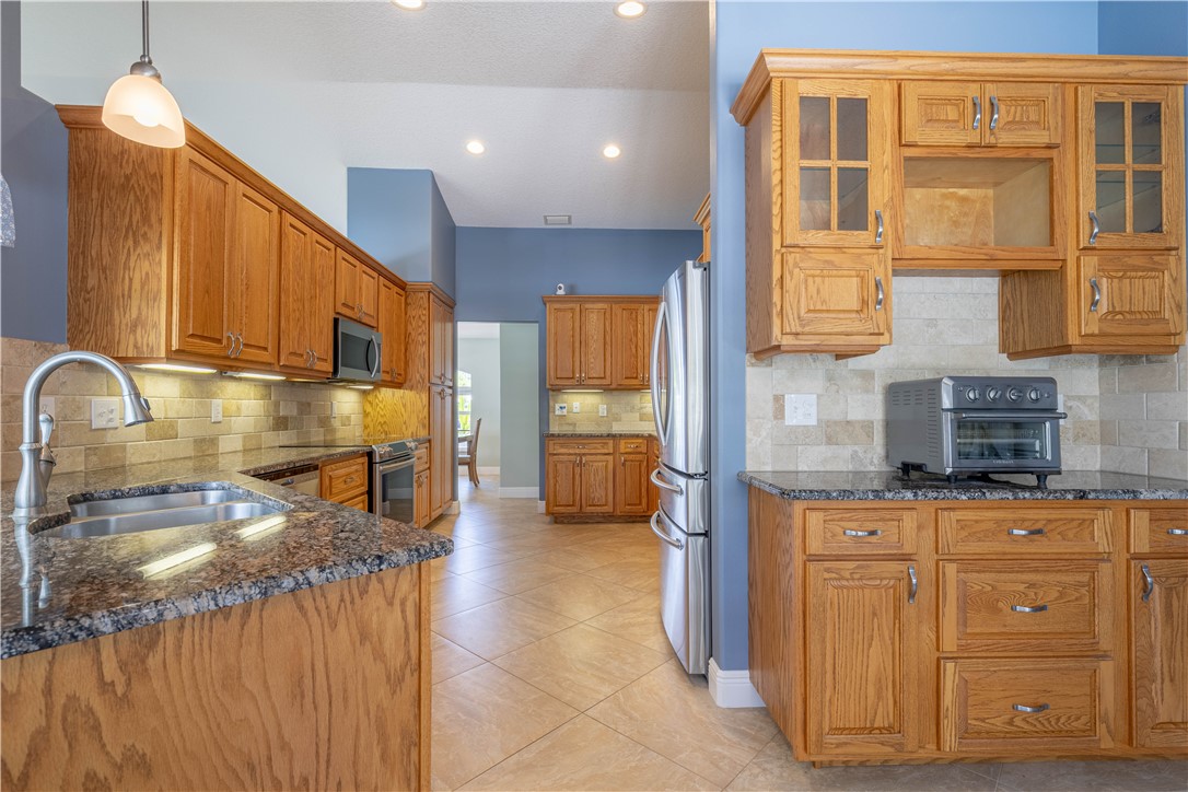 414 Ash Street Sebastian, FL 32958 - Photo 8 of 36 a kitchen with cabinets a sink and appliances