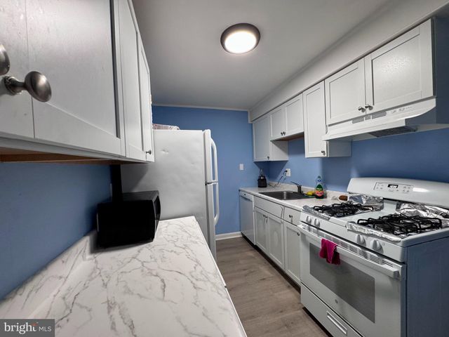 a kitchen with granite countertop cabinets and steel stainless steel appliances
