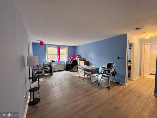 a living room with furniture window and a wooden floor