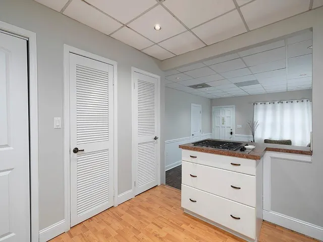 a kitchen with granite countertop cabinets a stove a sink and a window
