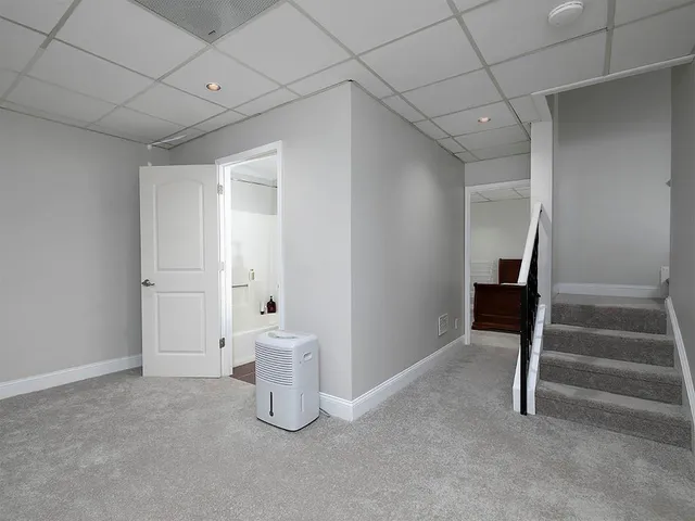 a view of an empty room with stairs and ventilation