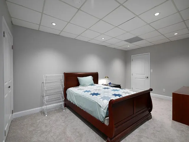 a bedroom with a bed and a night stand