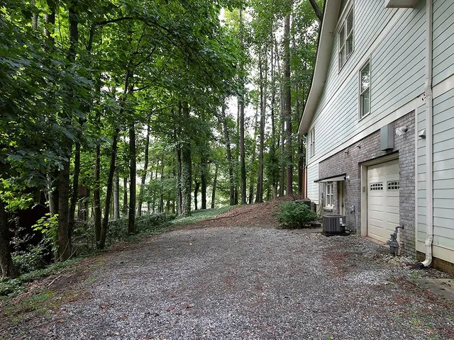 a view of a house with a tree in the background