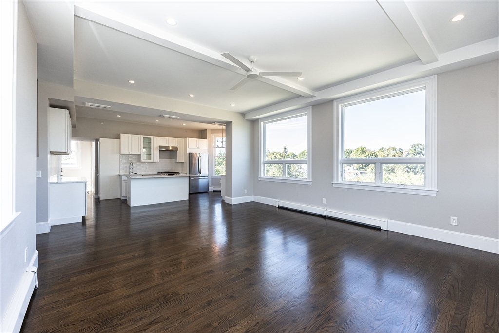 85 Regent Street, Unit 8 Boston, MA 02119 - Photo 11 of 30 a view of kitchen with stove and wooden floor