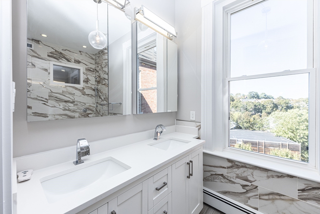 85 Regent Street, Unit 8 Boston, MA 02119 - Photo 20 of 30 a bathroom with a sink and a mirror