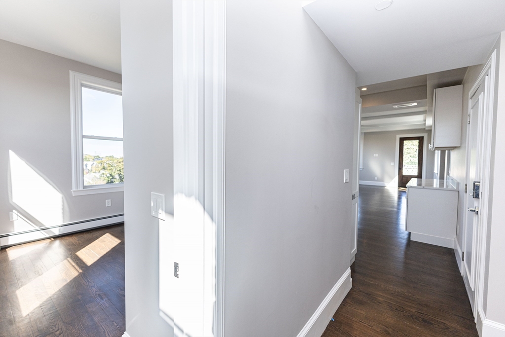 85 Regent Street, Unit 8 Boston, MA 02119 - Photo 21 of 30 a view of a hallway with windows