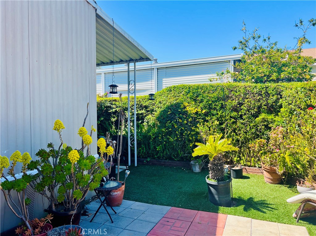26200 Frampton Avenue, Unit 74 Harbor City, CA 90710 - Photo 6 of 19 a front view of a house with a garden