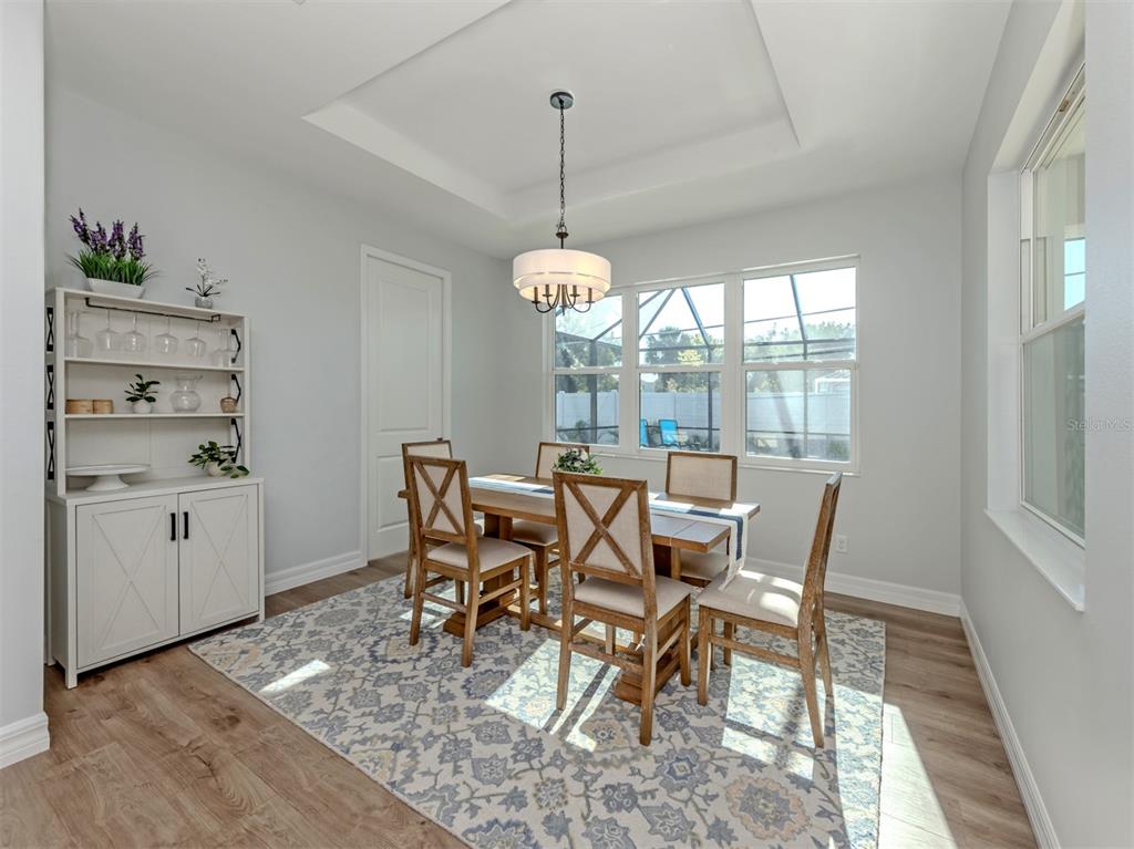 851 Linden Road Venice, FL 34293 - Photo 11 of 48 a dining room with furniture window wooden floor