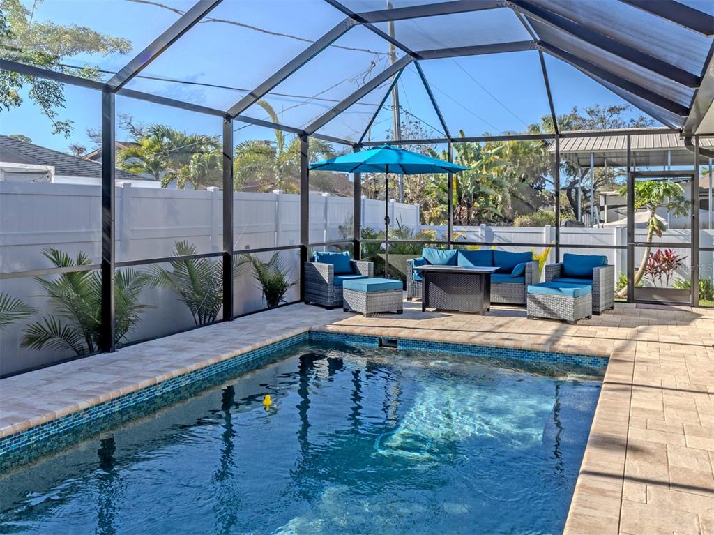 851 Linden Road Venice, FL 34293 - Photo 14 of 48 a view of a patio with chairs and table under an umbrella
