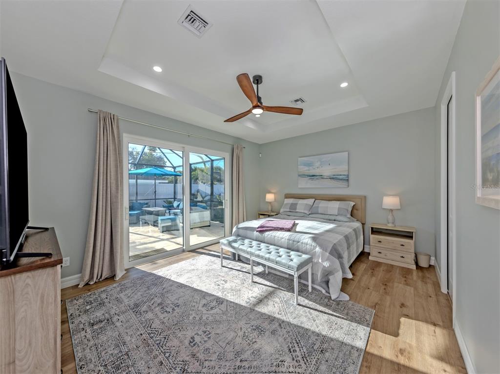 851 Linden Road Venice, FL 34293 - Photo 17 of 48 a bedroom with a bed and glass door