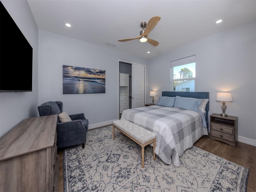 851 Linden Road Venice, FL 34293 - Photo 21 of 48 a spacious bedroom with a bed and a flat screen television