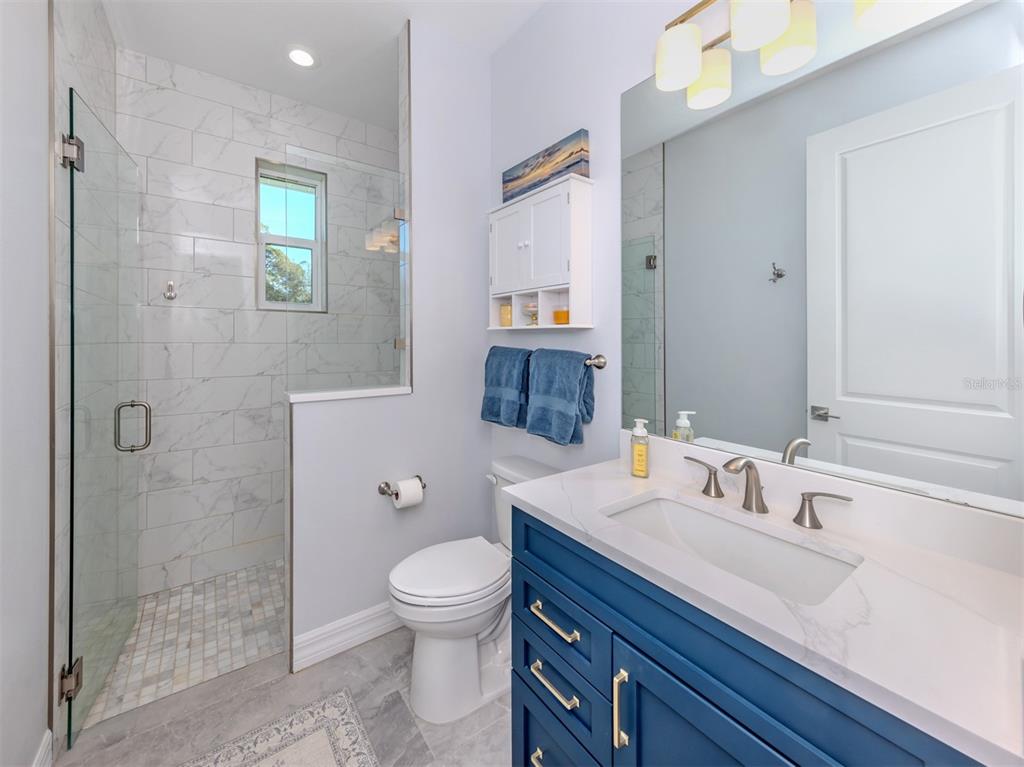 851 Linden Road Venice, FL 34293 - Photo 22 of 48 a bathroom with a sink a toilet and shower
