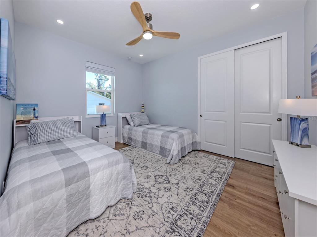 851 Linden Road Venice, FL 34293 - Photo 24 of 48 a bedroom with two beds and a table