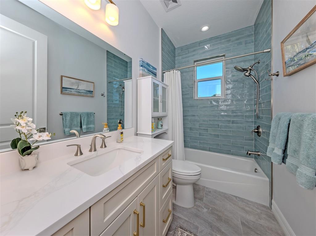 851 Linden Road Venice, FL 34293 - Photo 25 of 48 a bathroom with a sink a toilet and shower