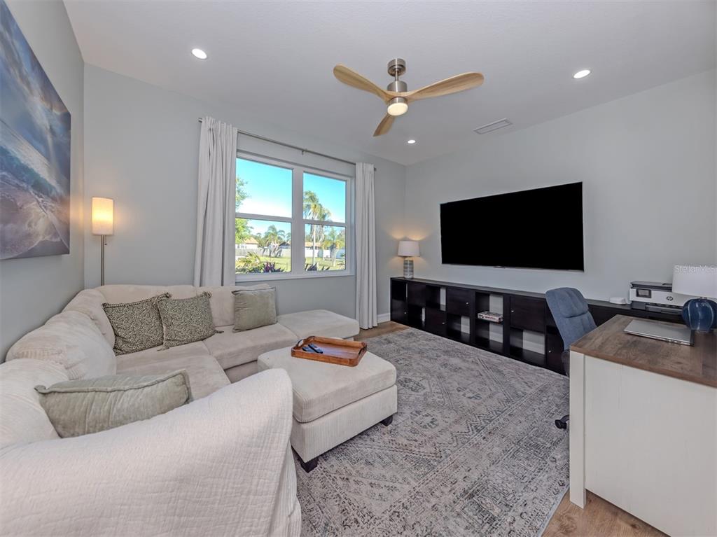 851 Linden Road Venice, FL 34293 - Photo 27 of 48 a living room with furniture and a flat screen tv
