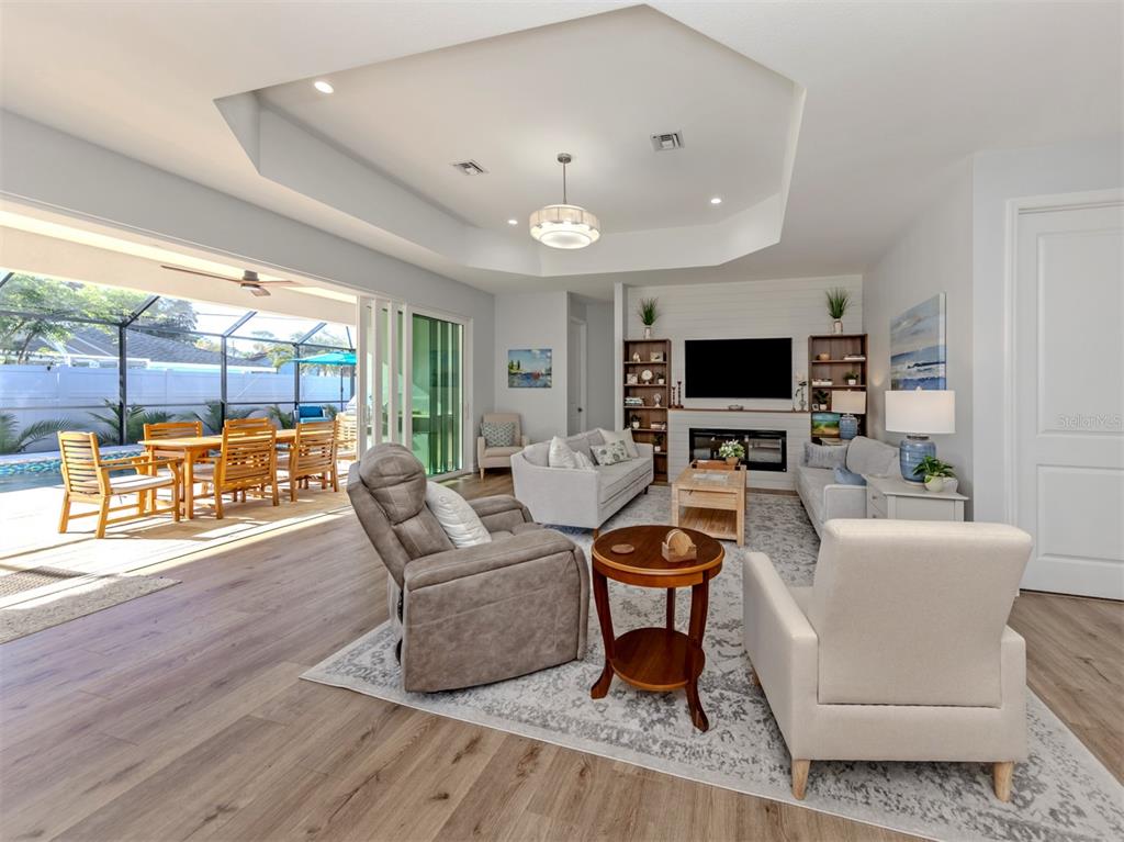 851 Linden Road Venice, FL 34293 - Photo 6 of 48 a living room with patio furniture and a flat screen tv