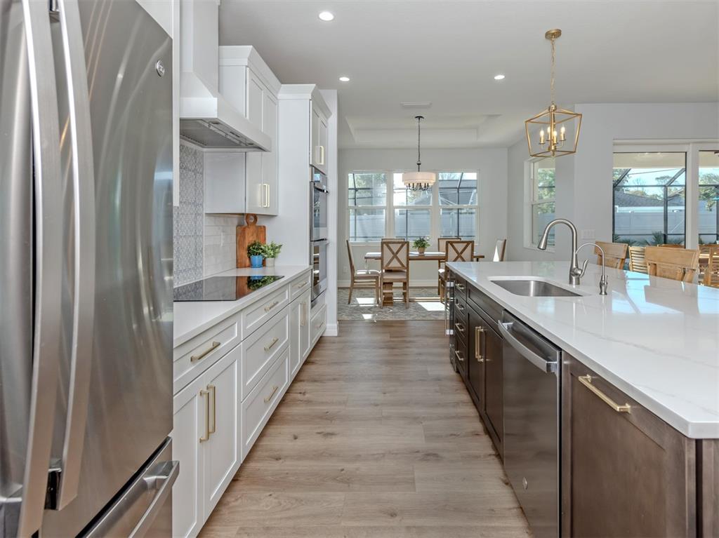 851 Linden Road Venice, FL 34293 - Photo 10 of 48 a large kitchen with stainless steel appliances a sink counter space and a view of living room