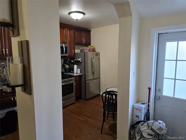 a kitchen with stainless steel appliances a refrigerator and a stove top oven