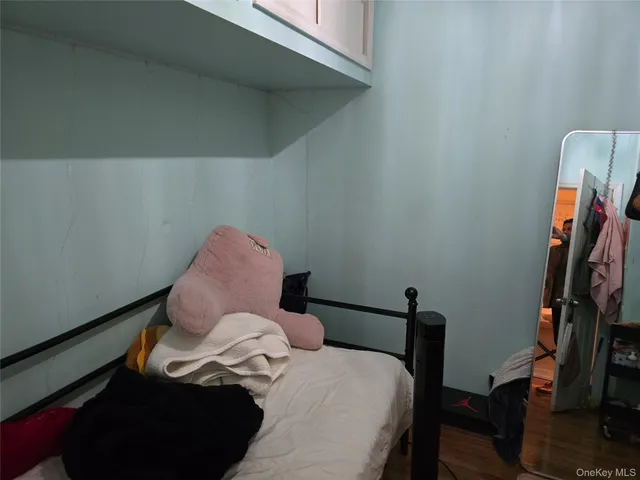 a bed sitting in a bedroom next to a window