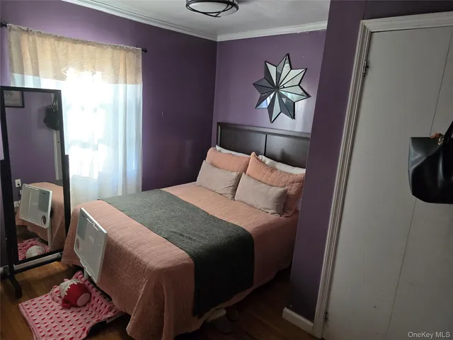 a bedroom with a bed and a painting on the wall