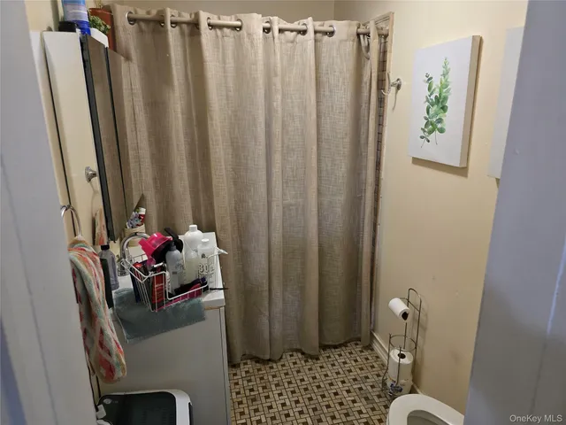 a bathroom with a toilet and a shower curtain
