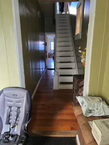 a view of entryway and hall with wooden floor