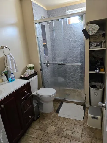 a bathroom with a toilet a sink and shower