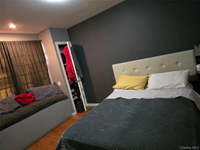 a bed sitting in a bedroom next to a window