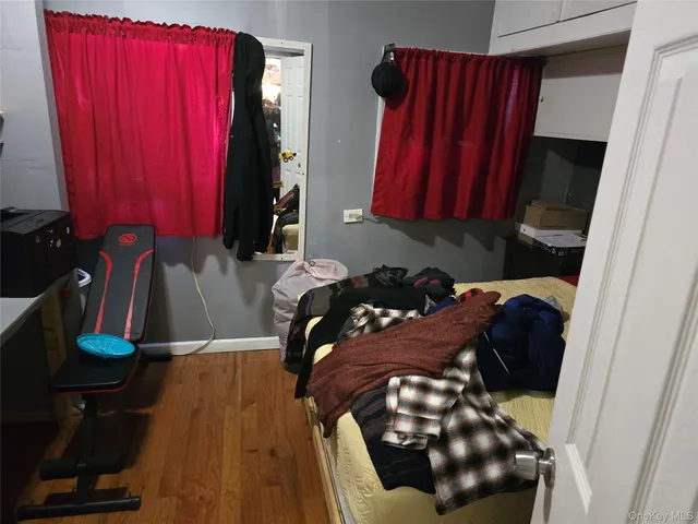 a view of a closet with clothes and shoes