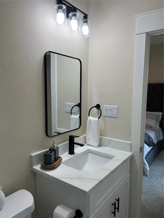 a bathroom with a toilet sink and mirror