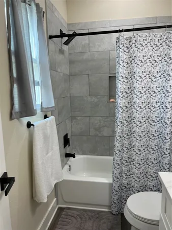 a bathroom with a toilet and a bathtub