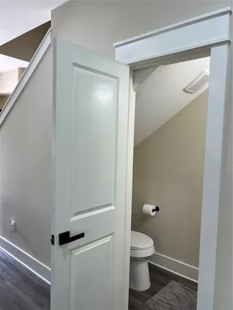 a bathroom with a granite countertop toilet and a shower