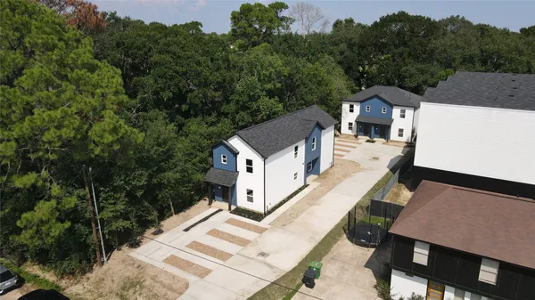 an aerial view of a house with a yard